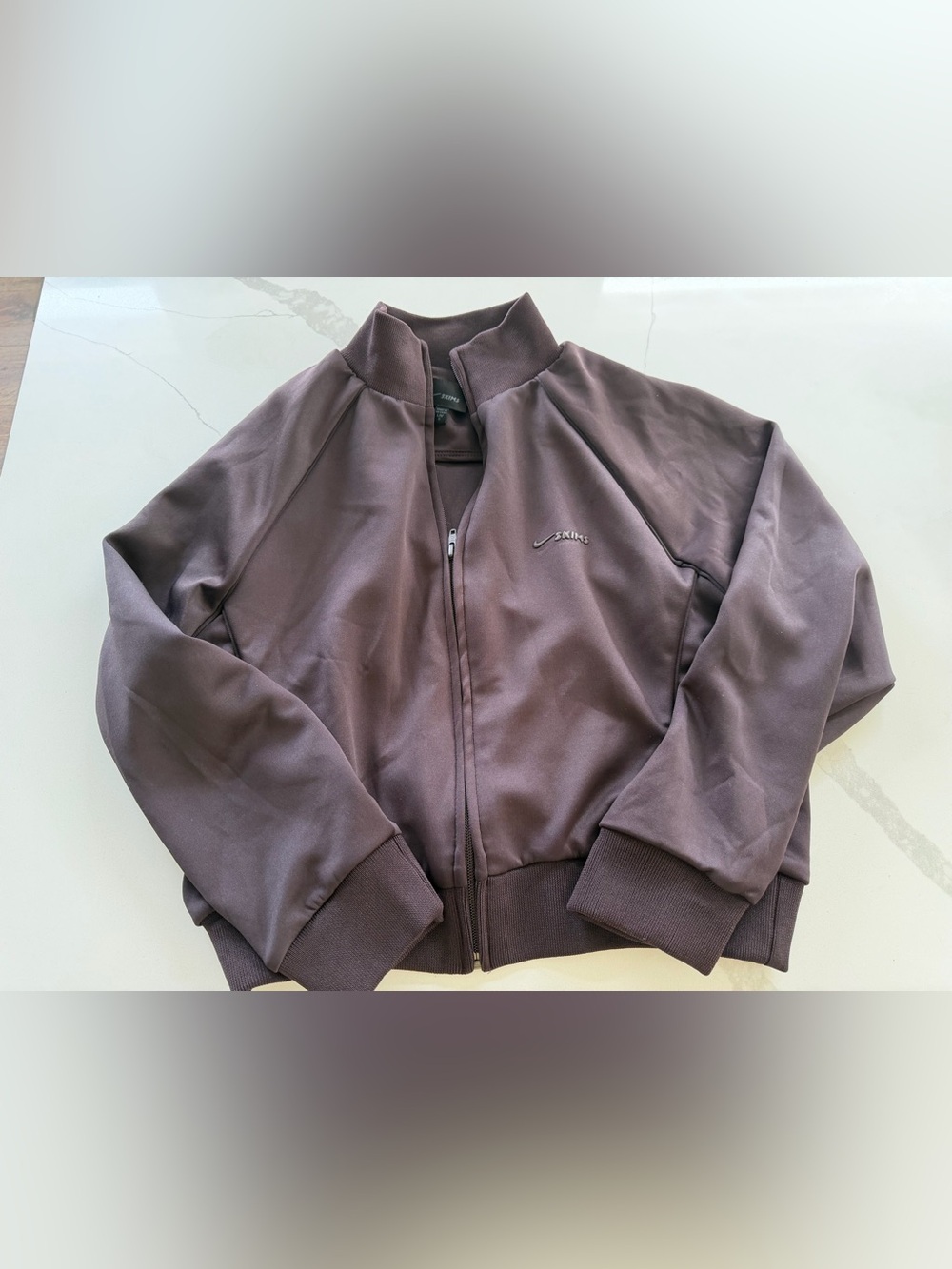 Nike x SKIMS Matte Tricot Track Jacket in the color Dark Roast